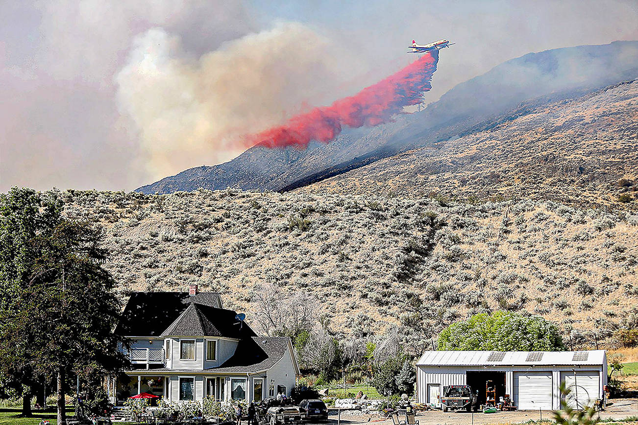 A plane drops fire retardant on the Palmer Mountain Fire last summer in north-central Washington. Laura Knowlton/Sound Publishing staff photo