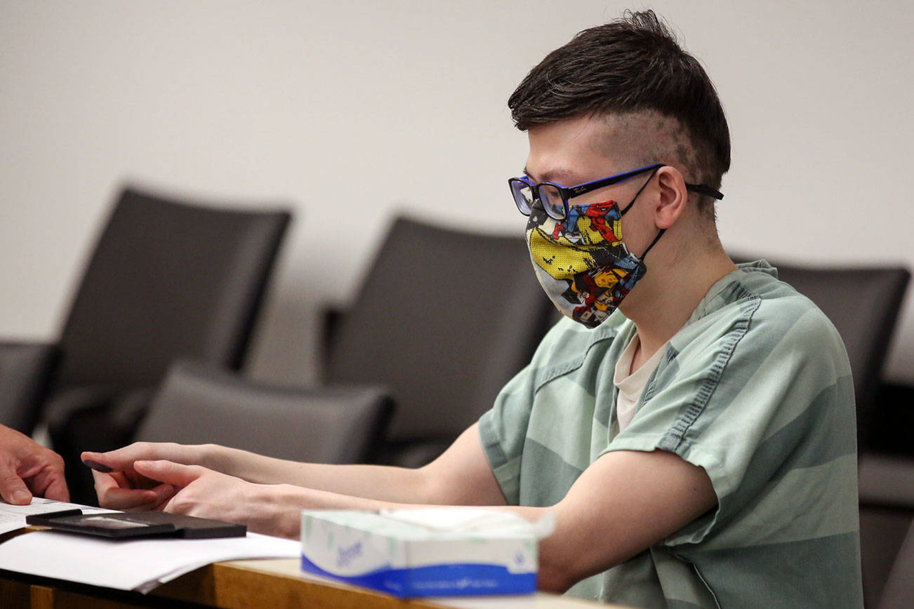 Sira Swope has his finger prints taken after being sentenced to more than six years in prison for a bomb threat and possession of child porn Thursday afternoon at Snohomish County Superior Court in Everett on June 24, 2021.  (Kevin Clark / The Herald)