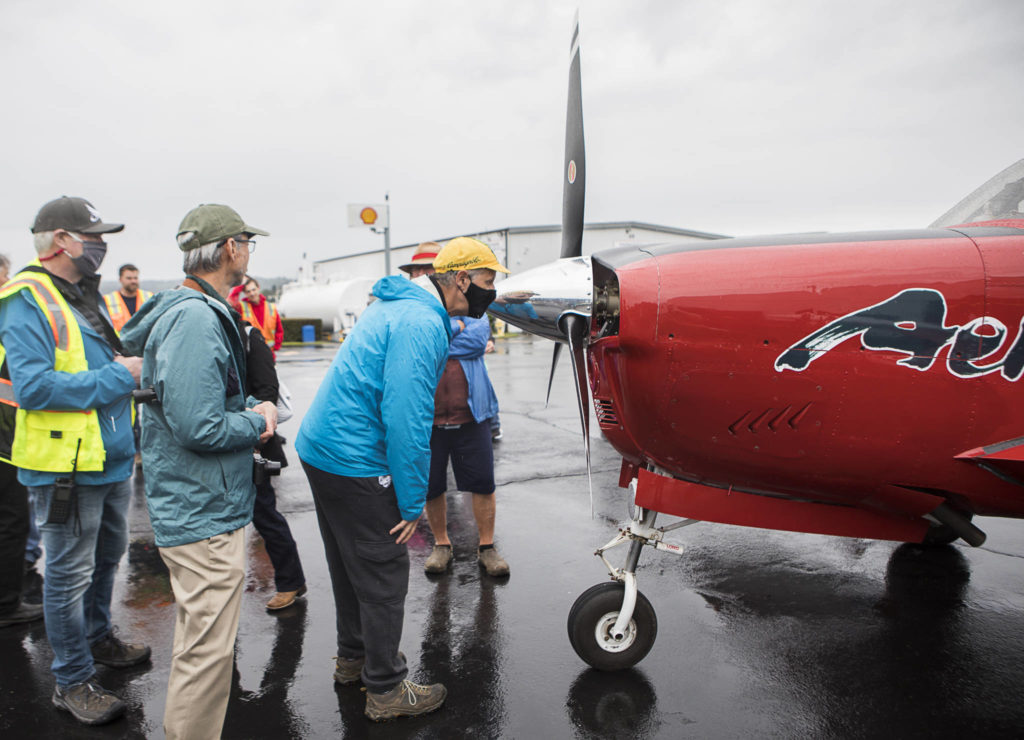People look at the propeller and a small amount of damage it sustained on Shinji Maeda’s flight on Friday, the final leg of his trip around the world. (Olivia Vanni / The Herald)
