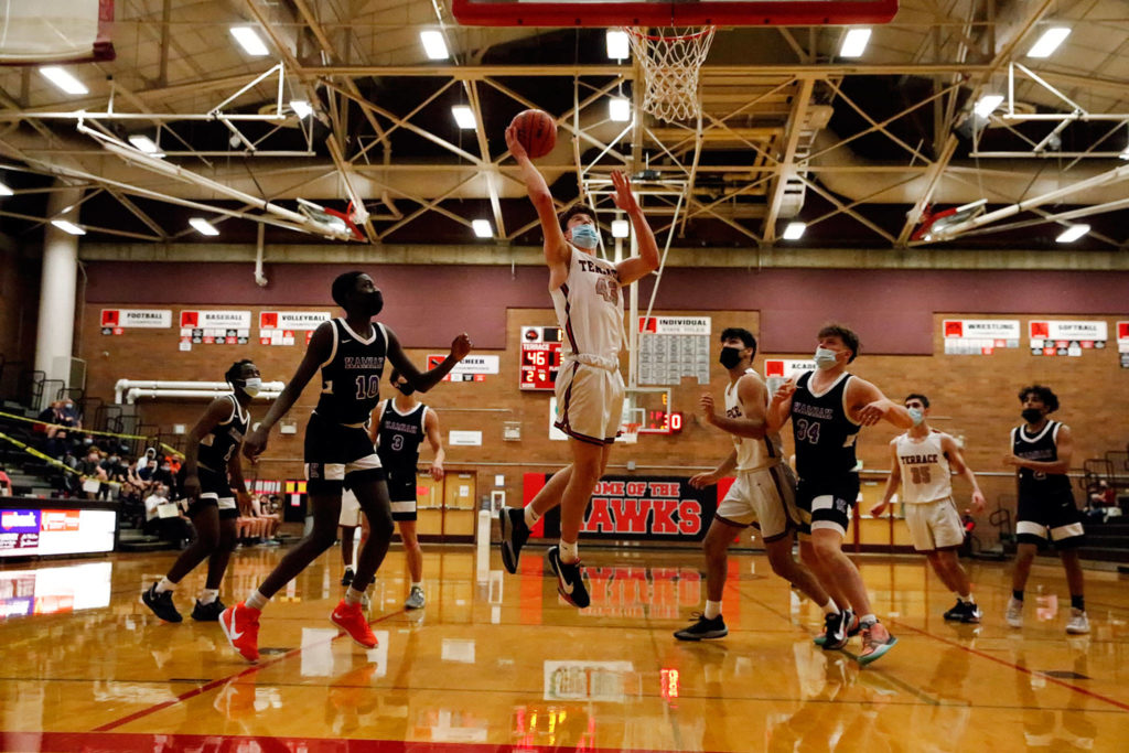 Mountlake Terrace’s Adison Mattix (center) goes for a layup during a game against Kamiak on Thursday evening at Mountlake Terrace High School. The Hawks won 65-59. (Kevin Clark / The Herald)
