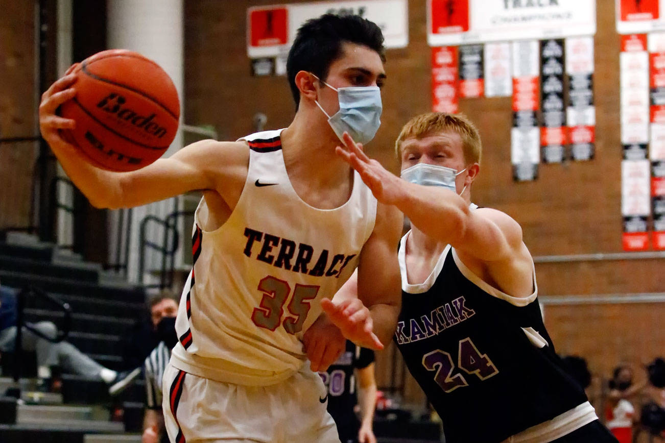 Mountlake Terrace's Vitaly Mkrtychyan controls the ball with Kamiak's Nolan Martin reaching across Thursday evening at Mountlake Terrace High School on June 10, 2021. The Hawks won 65-59. (Kevin Clark / The Herald)