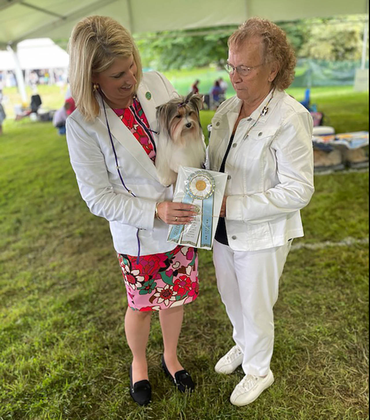 Hay Look Me Over, a Biewer terrier, with her handler, Molly Speckhardt, left, and owner Lynn McKee, of Lake Stevens. The 2-year-old terrier won a Westminster Kennel Club Dog Show ribbon for second among the girls in her class. (Submitted photo)