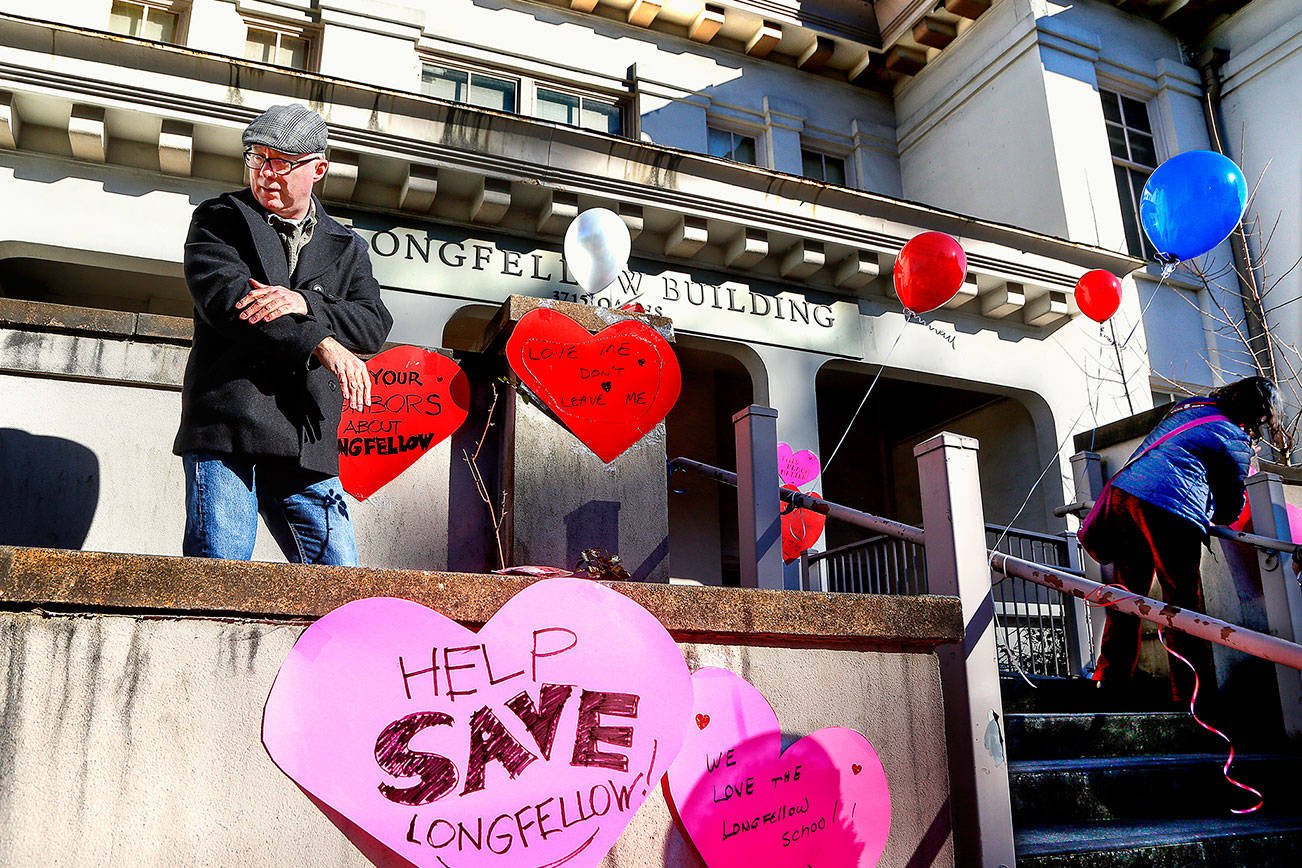 Everett's Patrick Hall was among people who put up signs in March to save the Longfellow School building.  He is now part of an advisory task force looking at options for the building, which the Everett School District had planned to tear down.  (Dan Bates / The Herald)