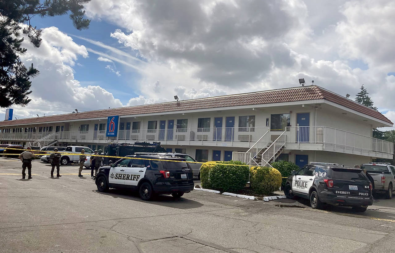 Officers surrounded a Motel 6 near Everett Tuesday morning after a reported rape. A man tried to flee but was subdued and arrested. (Ellen Dennis / The Herald)