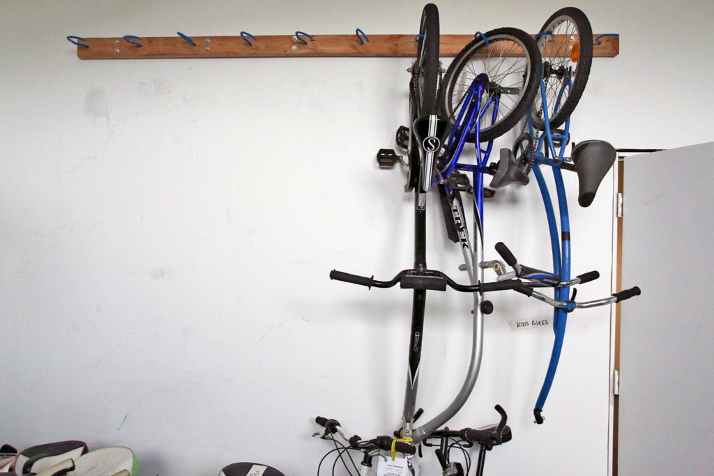 Tag-along bikes are stored in preparation for a garage sale at Sharing Wheels in Everett. (Kevin Clark / The Herald)
