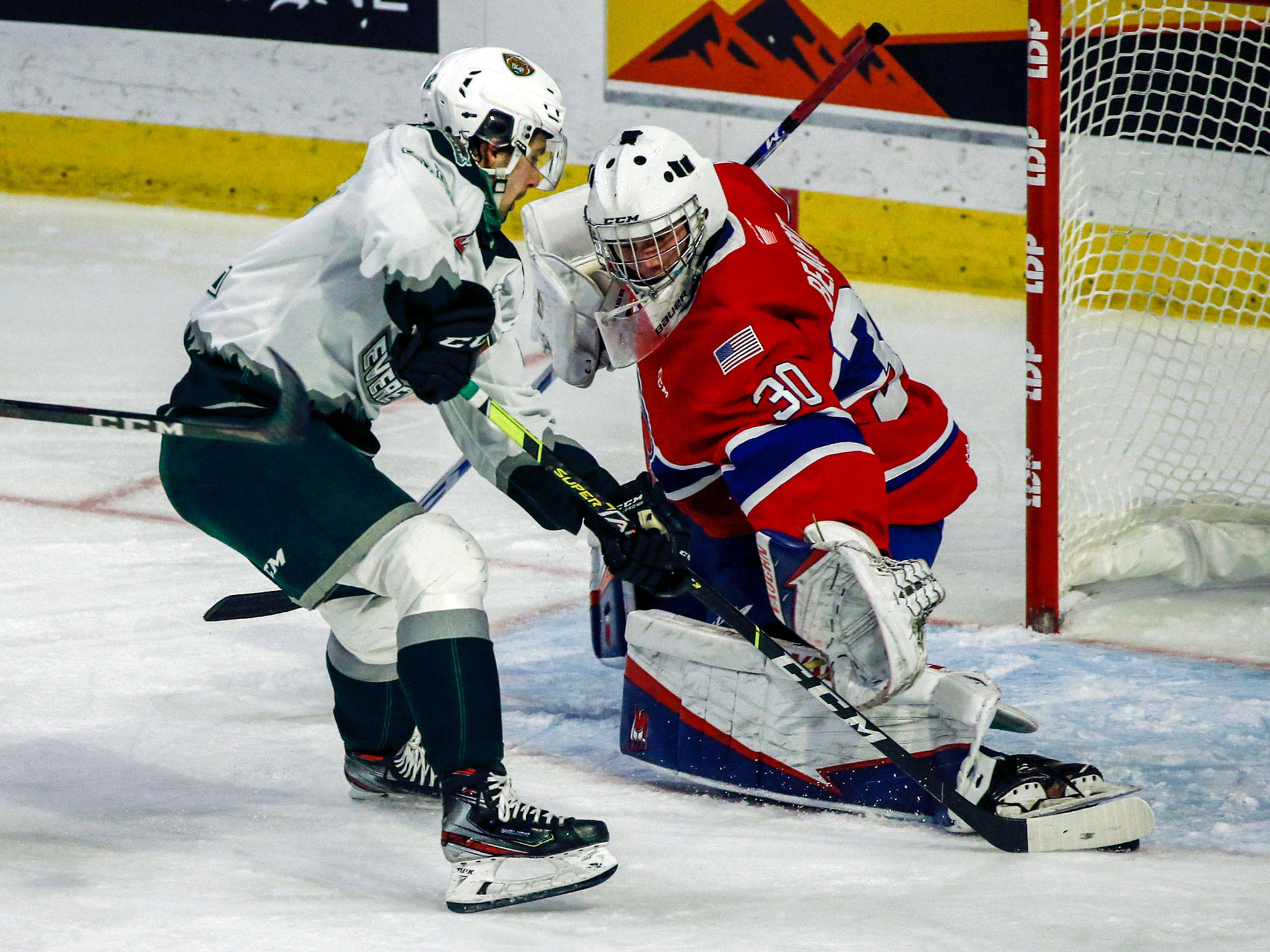 The Silvertips’ Cole Fonstad attempts a shot with as the Chiefs’ Mason Beaupit defends the net during a game on May 7, 2021, at Angel of the Winds Arena in Everett. (Kevin Clark / The Herald)