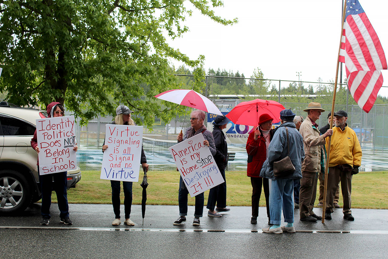Washingtonians for Change protesters rally in front of South Whidbey High School. (Karina Andrew / Whidbey News-Times)