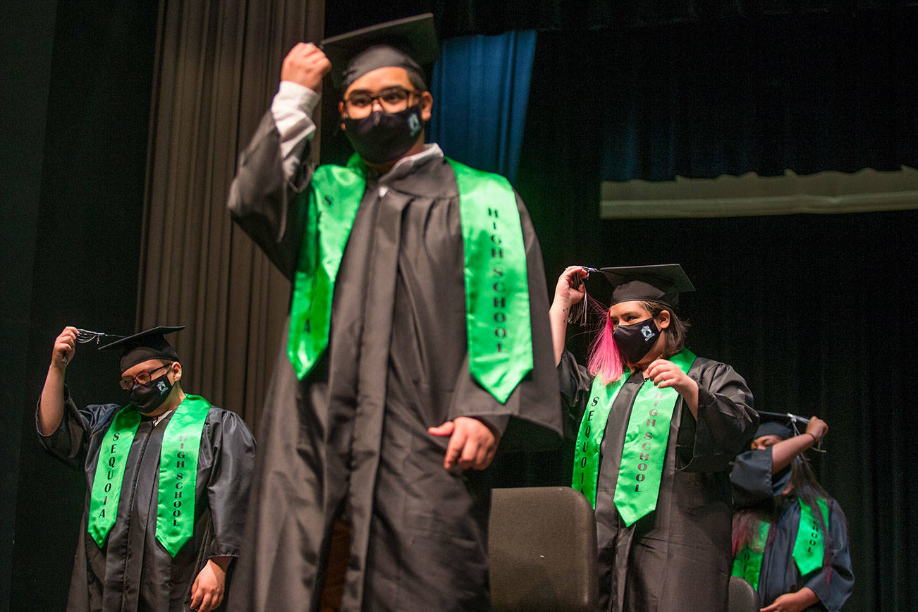 Sequoia High graduates move their tassels from one side to the other at the end of the graduation ceremony on Thursday, June 17, 2021 in Everett, Washington. (Andy Bronson / The Herald)