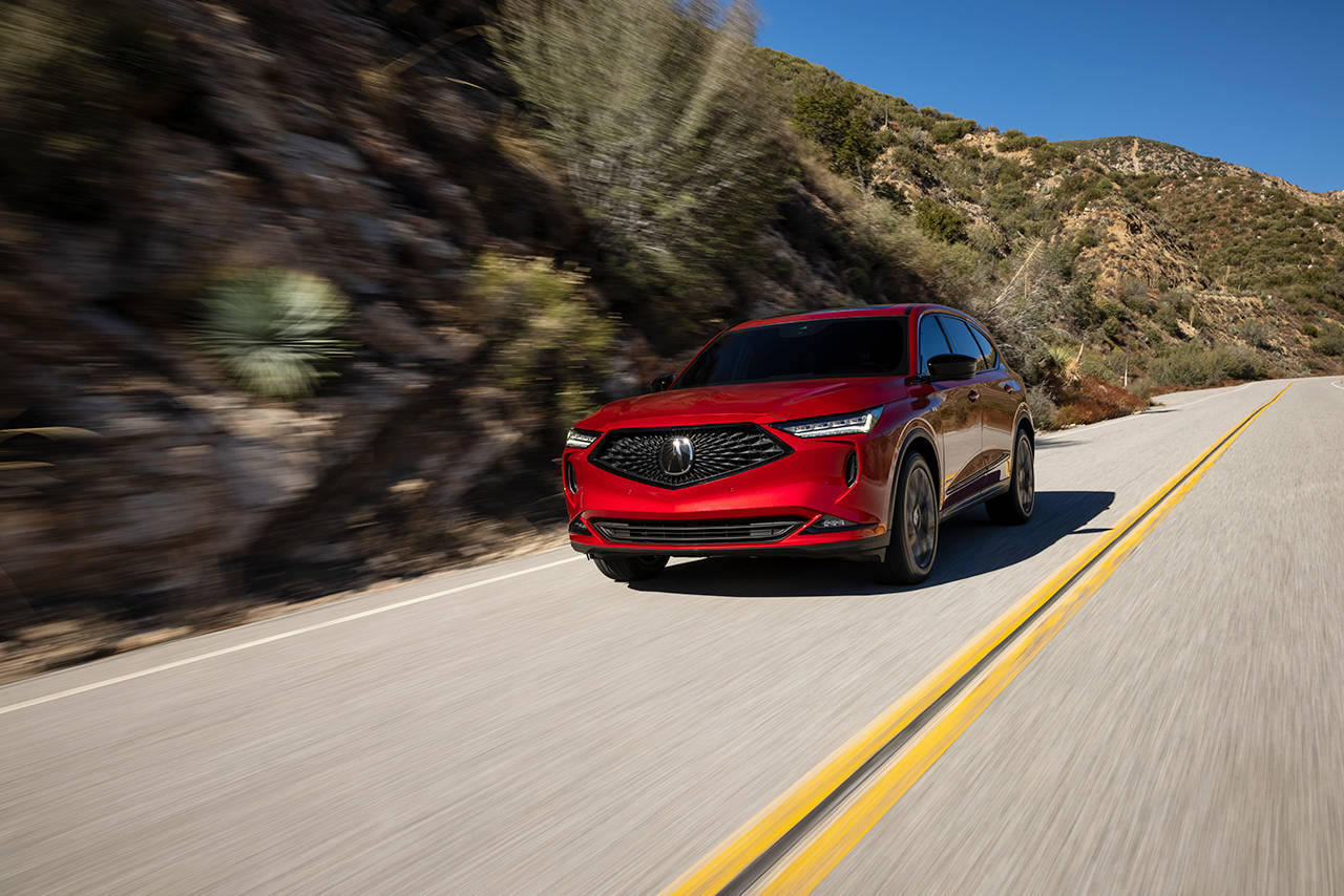 A blacked-out diamond pentagon grille and four-element LED headlights signal assertiveness in the 2022 Acura MDX. (Manufacturer photo)
