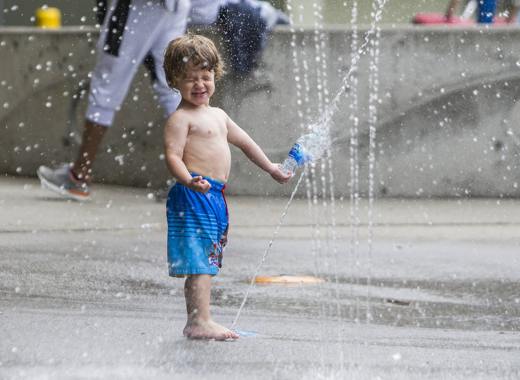 Wyatt Podoll, 2, plays in the Rotary Centennial Water Playground at Forest Park in Everett on Saturday. The splash pad reopened over the Memorial Day weekend as COVID restrictions were eased. (Olivia Vanni / The Herald)