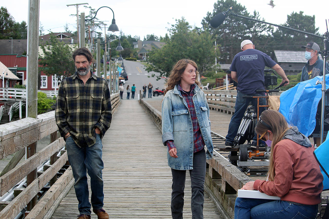 Chris Stack and Samantha Soule film a scene from “Midday Black, Midnight Blue” on the Coupeville wharf June 14. (Karina Andrew / Whidbey News-Times)
