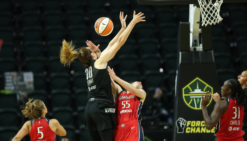 The Storm’s Breanna Stewart and the Mystics’ Theresa Plaisance collide during a game on Tuesday evening at Angel of the Winds Arena in Everett. (Andy Bronson / The Herald)
