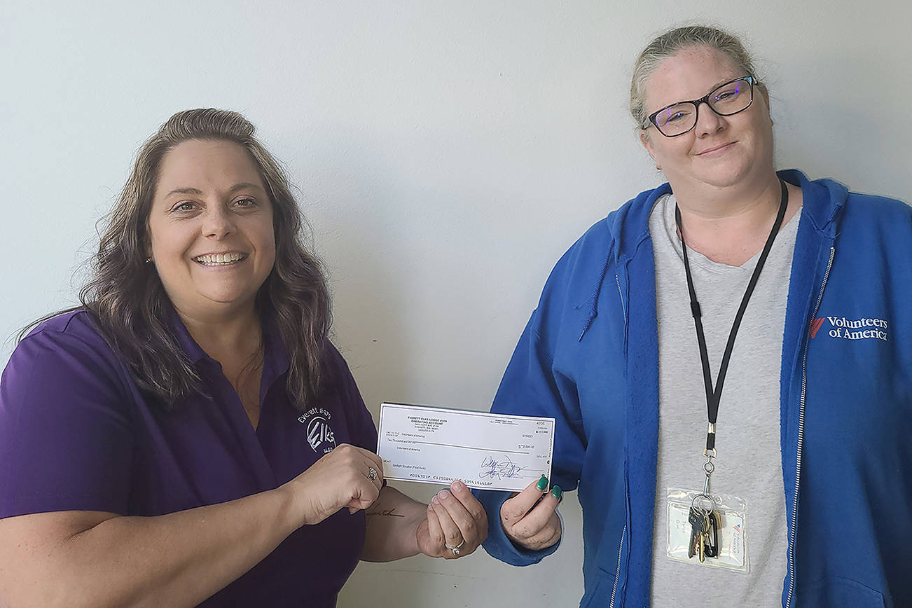 Wendy Cook, Everett Elks Lodge Exalted Ruler, gave Volunteers of American Food Bank Manager Tonya Gien a check for $2,000. (Everett Elks Lodge)