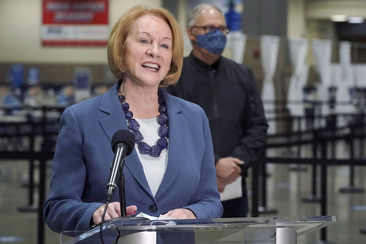 Seattle Mayor Jenny Durkan speaks at a news conference as Washington Gov. Jay Inslee looks on March 10 at the Lumen Field Events Center in Seattle. (AP Photo/Ted S. Warren, file)