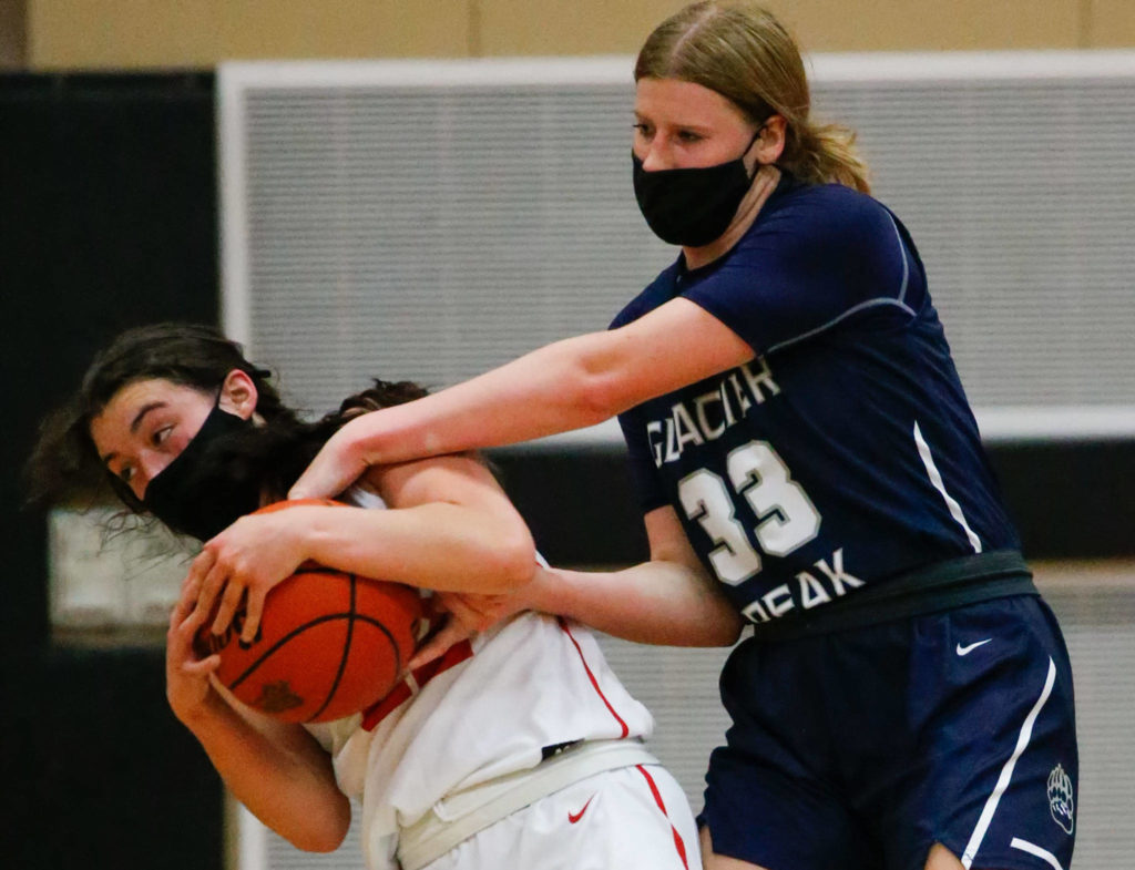 Snohomish’s Jada Andresen (left) and Glacier Peak’s Elyse Waldal lock up for a jump ball during a game at Snohomish High School on May 28. (Kevin Clark / The Herald)
