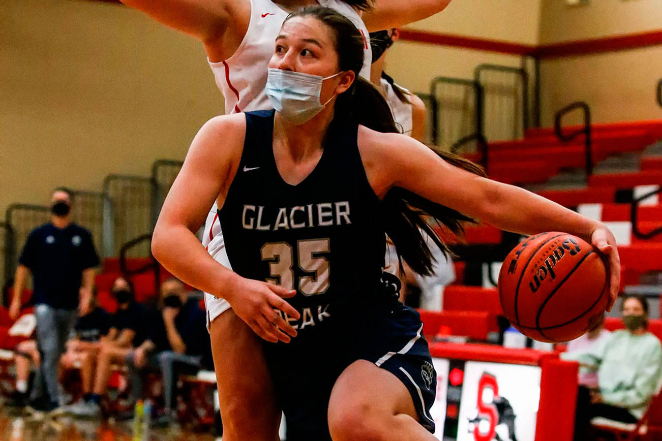 Glacier Peak's Maya Erling drives with Snohomish's Kyra Beckman defending Friday evening at Snohomish High in Snohomish on May 28, 2021. The Grizzles won 59-35. (Kevin Clark / The Herald)