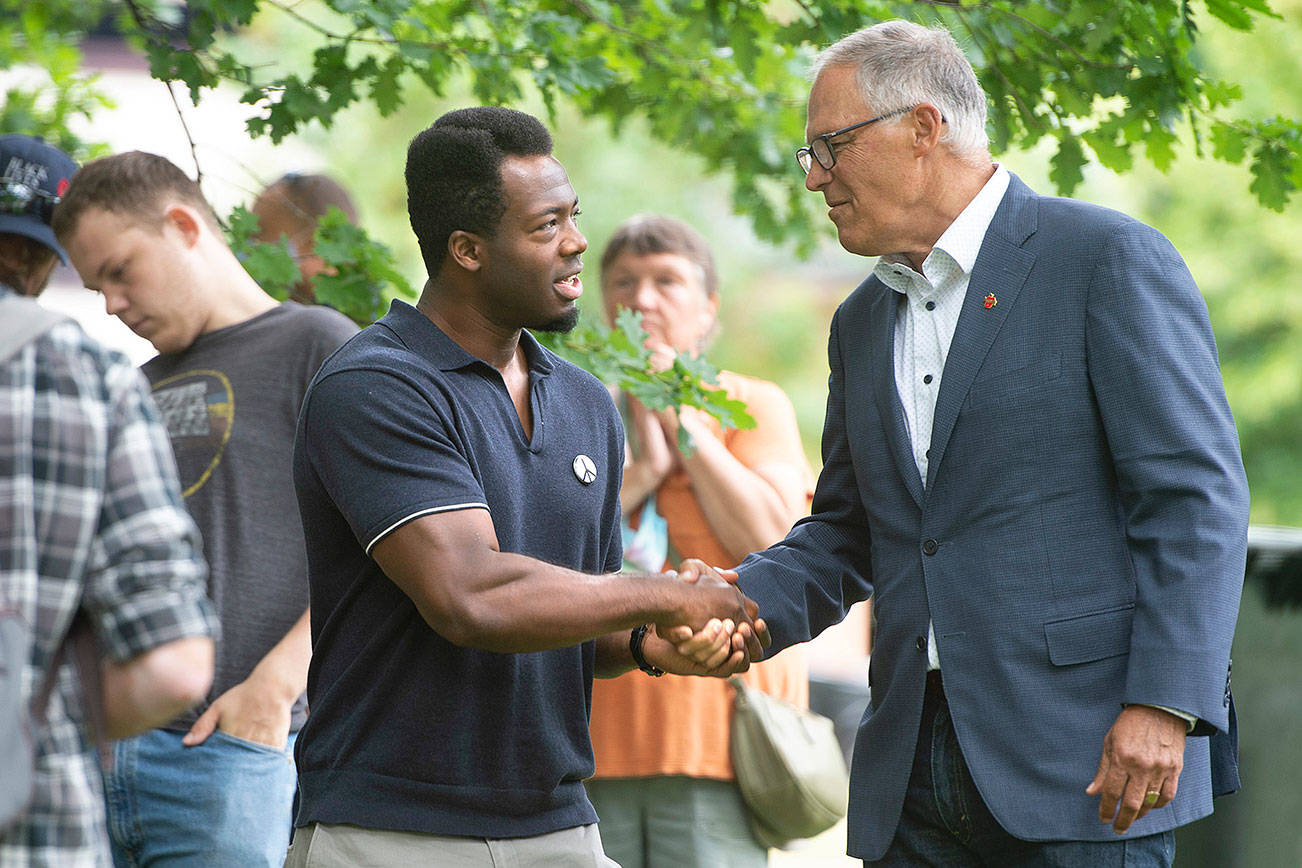 Kwabi Amoah-Foreson of Tacoma thanks Washington Governor Jay Inslee during the "Welcome Back, Washington" celebration at Wright Park in Tacoma, Wash., on Wednesday, June 30, 2021. (Tony Overman/The News Tribune via AP)