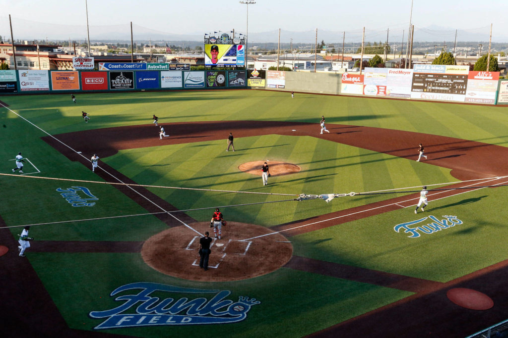 The AquaSox have the bases load in the first inning of a game against the Canadians on Tuesday evening at Funko Field in Everett. (Kevin Clark / The Herald)
