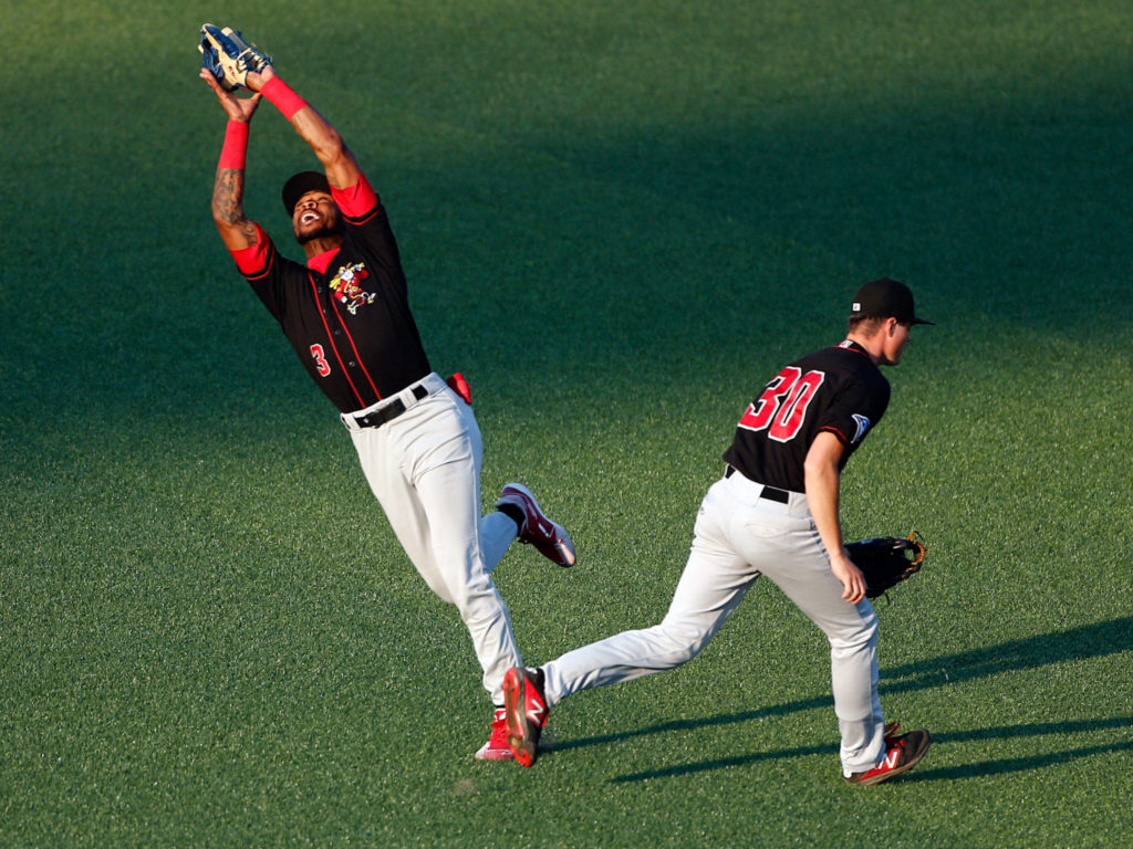 The Canadians’ DJ Neal fields a pop-up, calling off Tanner Morris during a game against the AquaSox on Tuesday evening at Funko Field in Everett. (Kevin Clark / The Herald)
