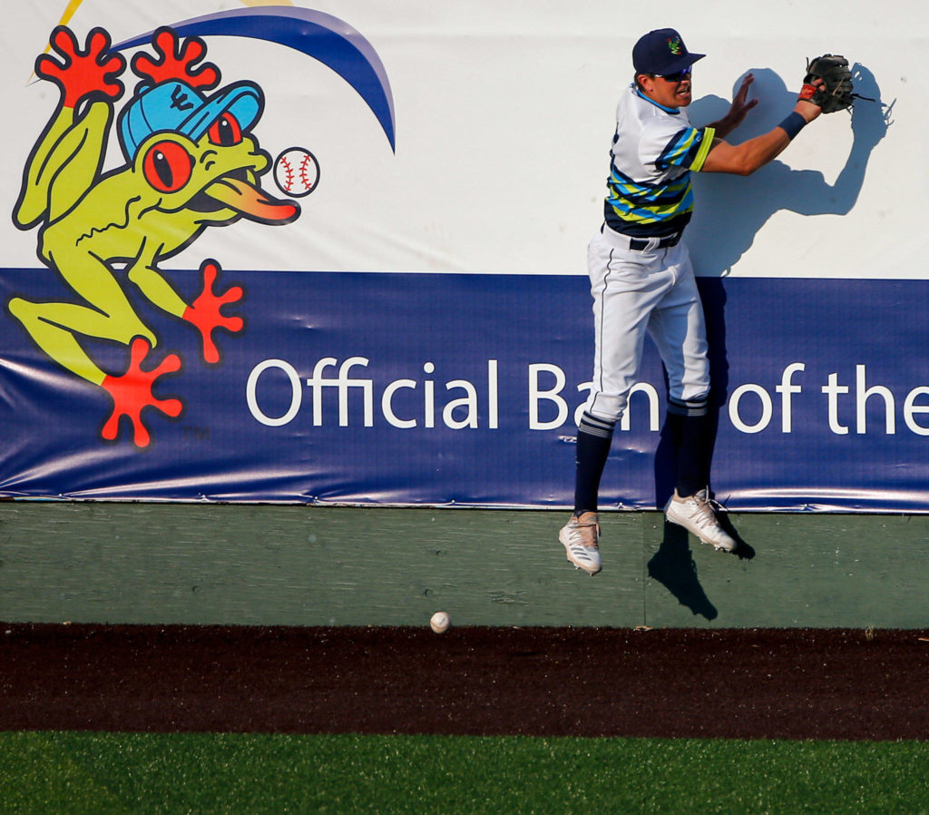 The AquaSox’s Jack Larsen can’t field a hit by a Canadians better during a game Tuesday evening at Funko Field in Everett. (Kevin Clark / The Herald)
