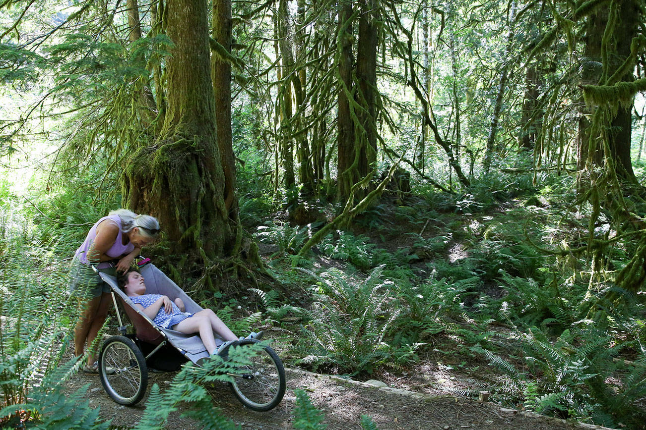 Karen Sample with her daughter Erin take in the view on the Erinswood Trail. The 0.6-mile loop is an ADA-accessible companion trail to the Leovy Trail in Index on July 6, 2021.  (Kevin Clark / The Herald)