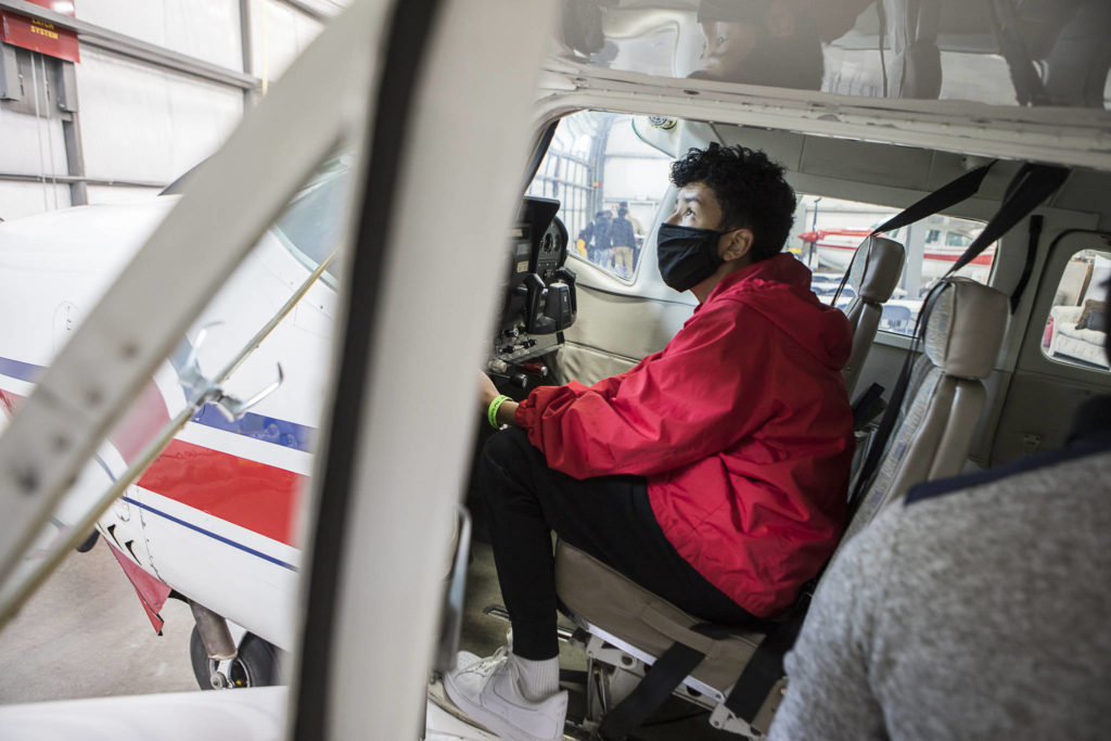 Jackson Ishida, 13, runs through a preflight check during a Red-Tailed Hawks Flying Club program at Arlington Municipal Airport. (Olivia Vanni / The Herald)
