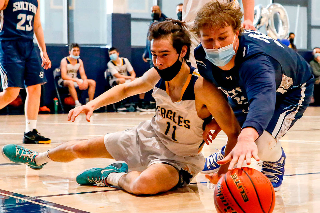 Eastside Prep's Bohan Shakes (left) and Sultan's Kobe Koehler reach for a loose ball Thursday evening at Eastside Prep in Kirkland on June 17, 2021.  (Kevin Clark / The Herald)