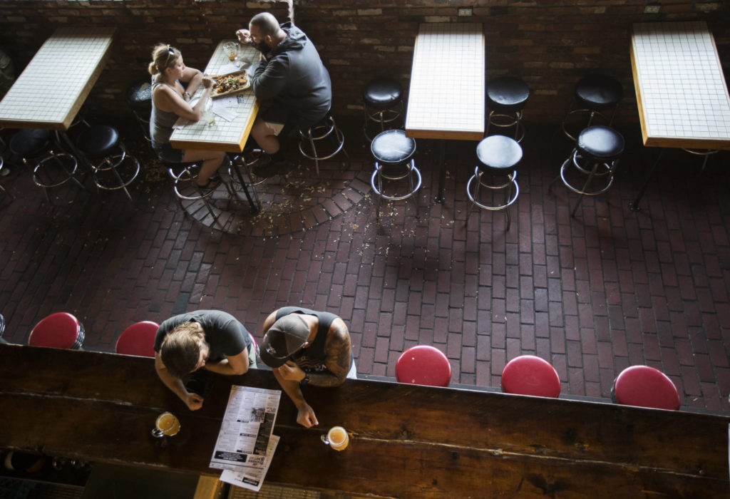 People sit are the bar top at Diamond Knot Brewery & Alehouse on Friday in Mukilteo. (Olivia Vanni / The Herald)
