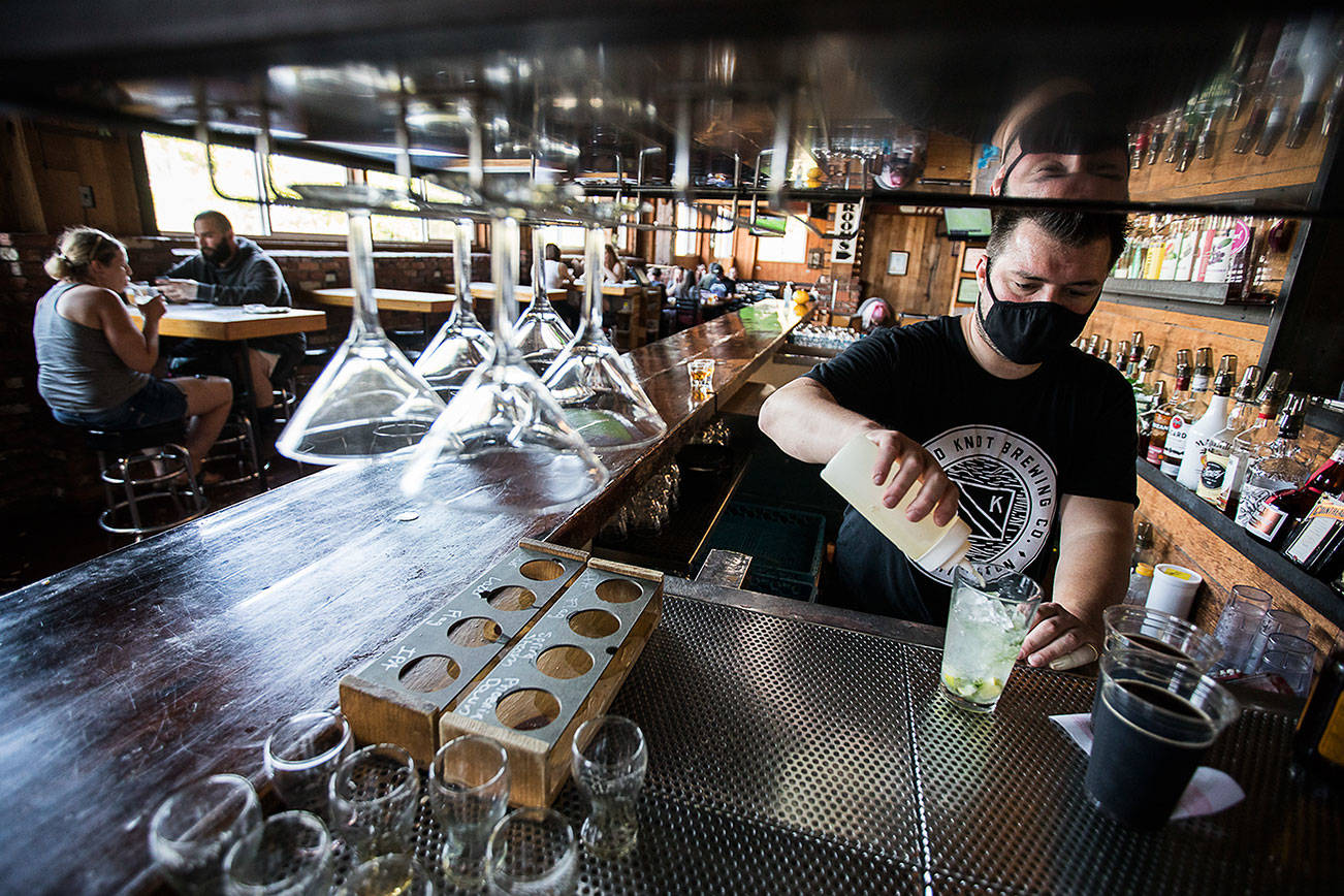 Brian Styron works on a drink at Diamond Knot Brewery & Alehouse on Friday, July 2, 2021 in Mukilteo, Wa. Across Snohomish County, restaurants, bars and other businesses are back at full capacity, following the drop of COVID-19 restrictions earlier this week. (Olivia Vanni / The Herald)