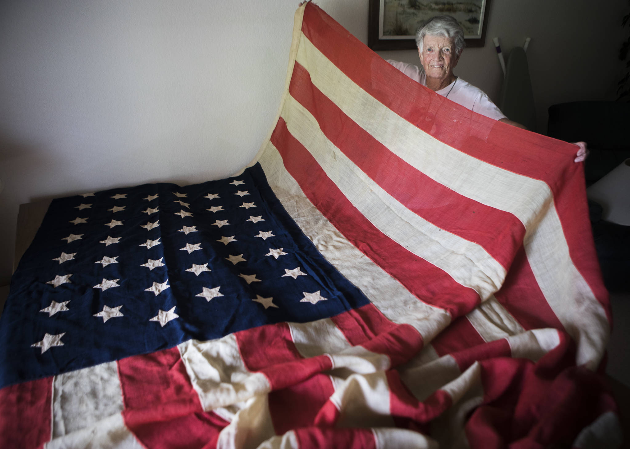 Pat Colyer with her 44-star American flag at her home Thursday in Mukilteo. (Olivia Vanni / The Herald)