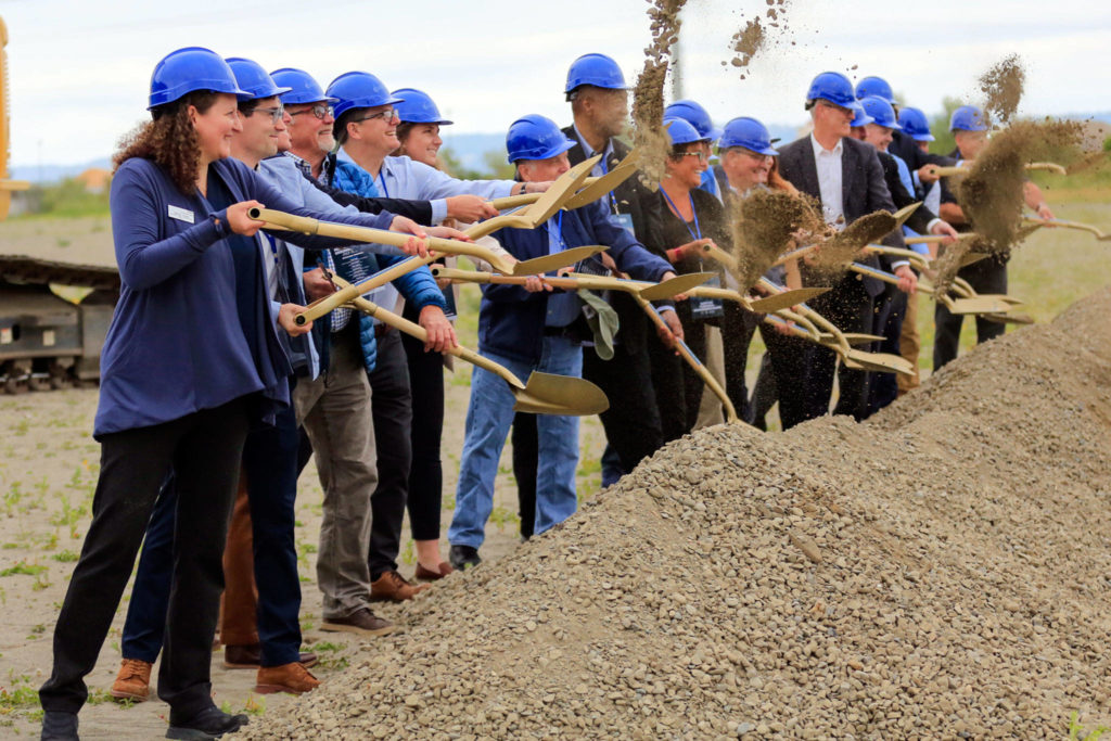 Community leaders and officials break ground at the Port of Everett’s Norton Terminal, on the former Kimberly-Clark mill site, Thursday morning in Everett. (Kevin Clark / The Herald) 
