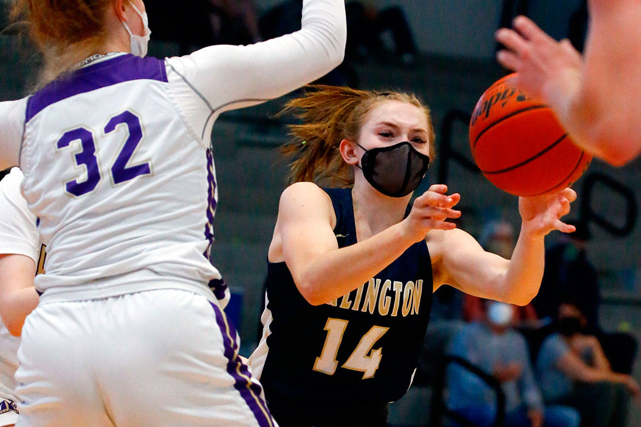 Arlington's Keira Marsh attempts a pass with Lake Stevens' Cori Wilcox defending Wednesday evening at Lake Stevens High School on June 9, 2021. The Eagles won 80-71. (Kevin Clark / The Herald)