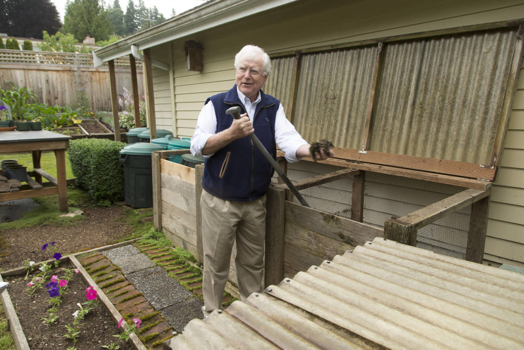 Bill Taylor home shows off his compost bins during a tour of his garden Tuesday in Edmonds. (Andy Bronson / The Herald)
