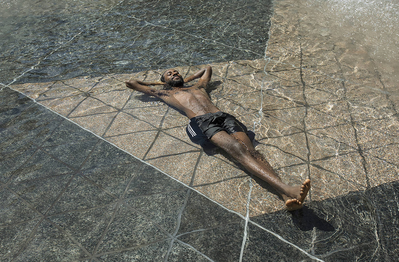 Kais Bothe relaxes in the cool in the city hall pool, as temperatures hit 37 degrees Celsius (98.6 Fahrenheit) in Edmonton, Alberta, on June 30. (Jason Franson/The Canadian Press via AP, file)