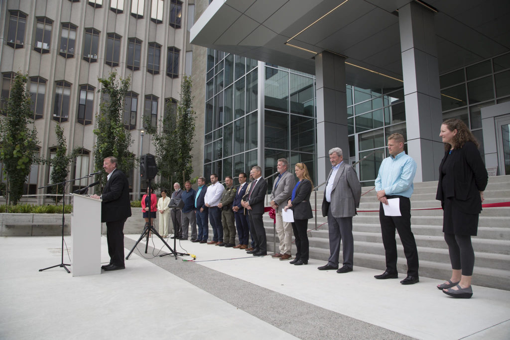 Backed by Snohomish County leaders and representatives from labor, construction companies and others, Snohomish County Executive Dave Somers speaks at a ribbon-cutting ceremony marking the completion of the Snohomish County Courthouse remodel Thursday in Everett. (Andy Bronson / The Herald)
