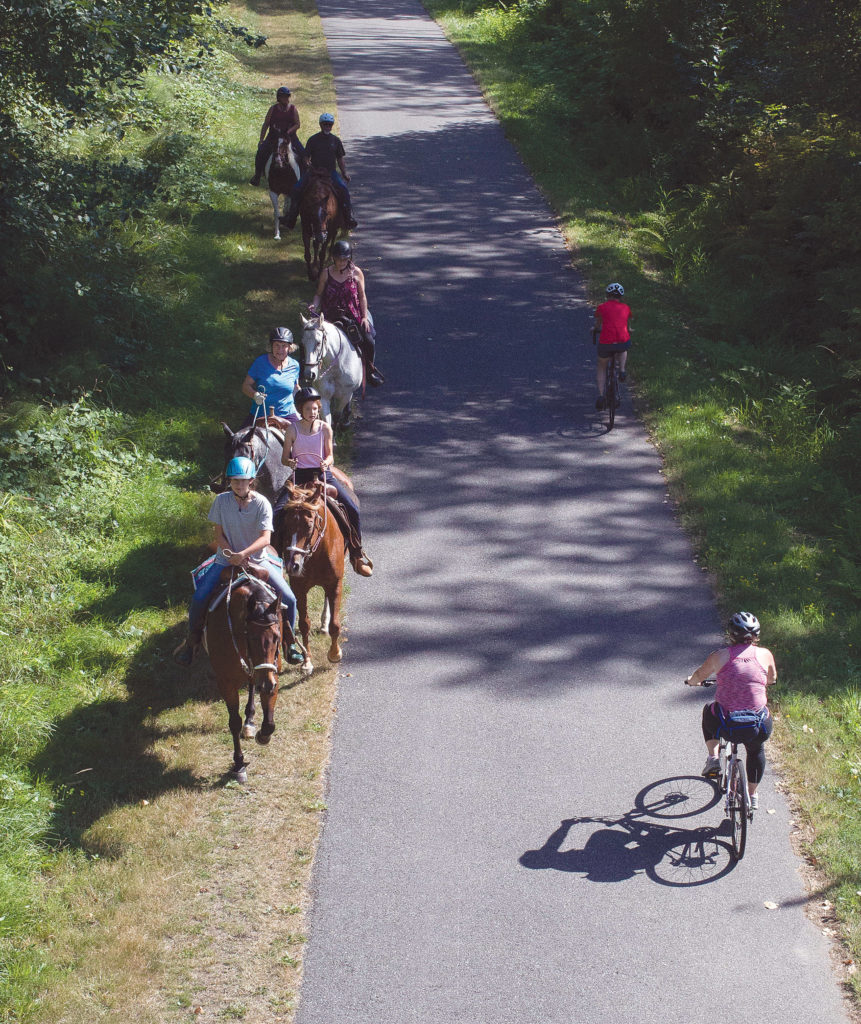 Horse riders and cyclists share the trail near Hilltop Road between Arlington and Marysville. (Andy Bronson / The Herald)
