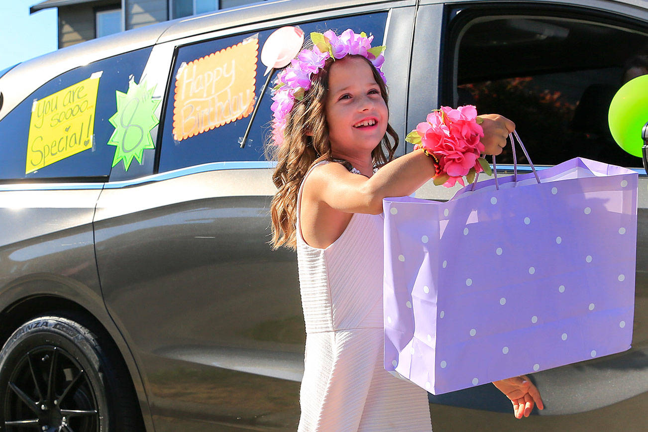 Essie Klopfenstine hands off one of her birthday presents Tuesday afternoon in Marysville on July 13, 2021. (Kevin Clark / The Herald)