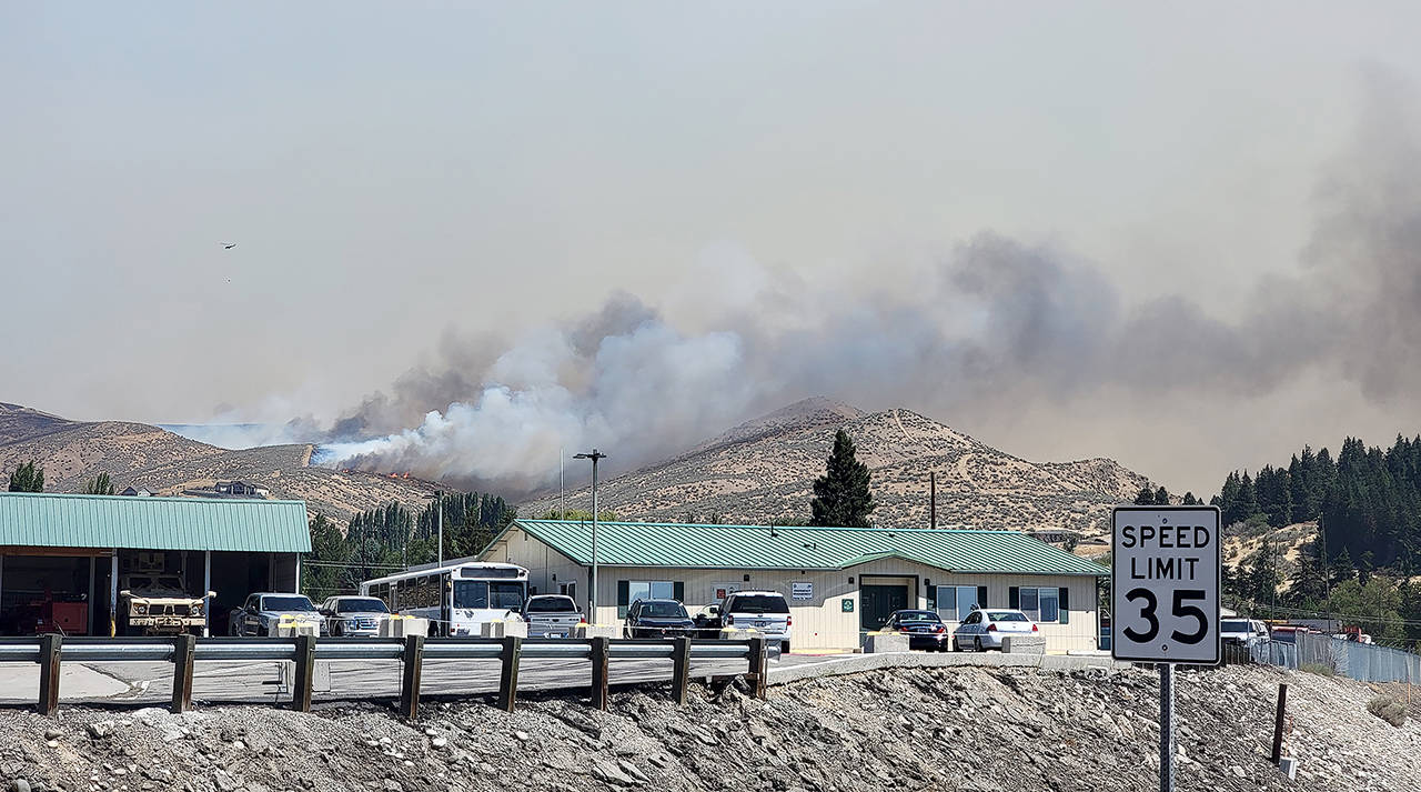 The Red Apple Fire was threatening homes, apple orchards and an electrical substation, but no structures have been lost, officials said. (Washington State Department of Transportation)