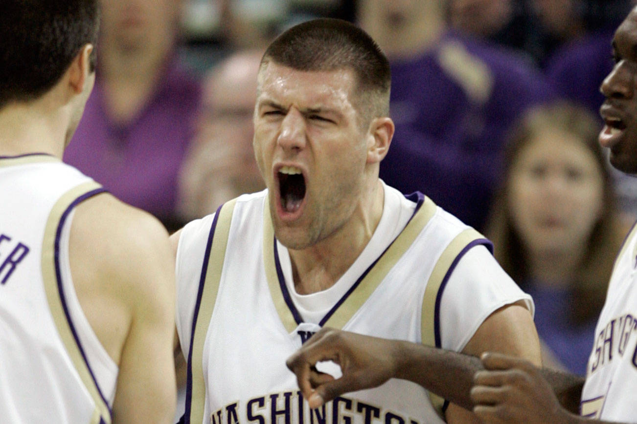 Washington forward Jon Brockman (40) celebrates a play with guard Brandon Burmeister (11) and forward Quincy Pondexter, right, in the first half of a college basketball game at Hec Edmundson Pavilion in Seattle, Saturday, Feb. 11, 2007. (AP Photo/Joe Nicholson)