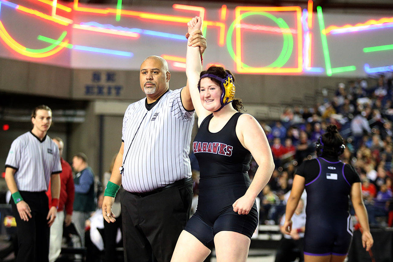 Marysville-Pilchuck's Alivia White is all smiles as her arm is raised after ;inning Connell's Rosa Saucedo-Ramirez in their championship match at Mat Classic XXXII in the Tacoma Dome on Saturday, Feb. 22, 2020 in Tacoma, Wash. (Andy Bronson / The Herald)