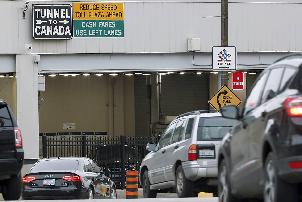 In this March 16, 2020 photo, vehicles enter the Detroit-Windsor Tunnel in Detroit to travel to Canada. (AP Photo/Paul Sancya, File)