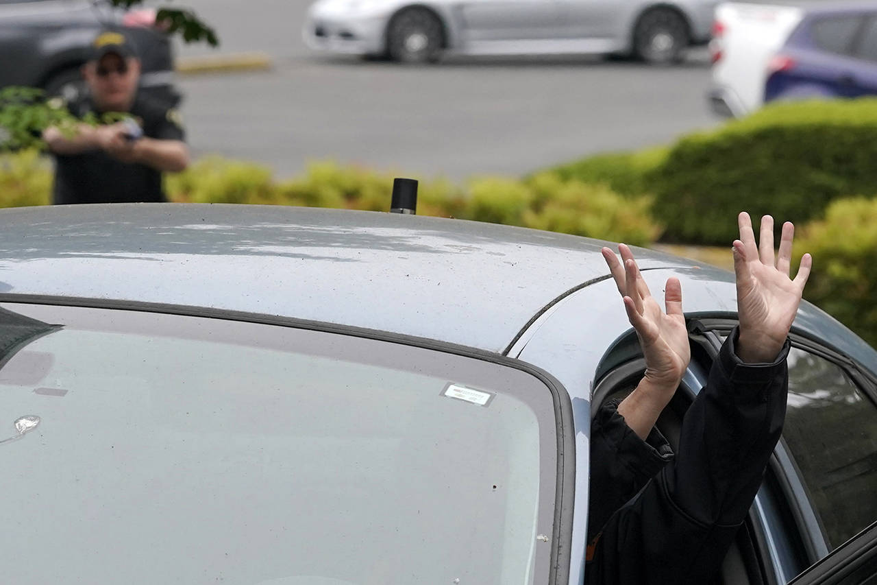 An instructor playing the role of a suspect in a vehicle sticks her hands out of a car door during a training class at the Washington state Criminal Justice Training Commission on July 14 in Burien. Washington state is embarking on a massive experiment in police reform and accountability following the racial justice protests that erupted after George Floyd’s murder last year, with nearly a dozen new laws that took effect Sunday, July 25, but law enforcement officials remain uncertain about what they require in how officers might respond — or not respond — to certain situations, including active crime scenes and mental health crises. (AP Photo/Ted S. Warren)