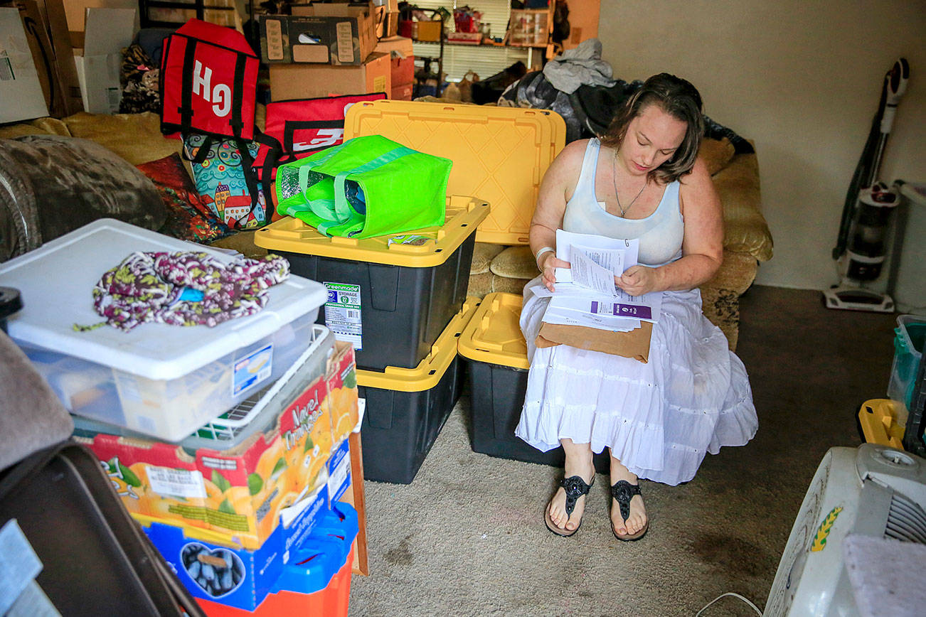 Hilary Lohman works to pack her home in the Whispering Pines Apartments complex which is slated to be demolished in October but must be vacated on August 31. (Kevin Clark / The Herald)
