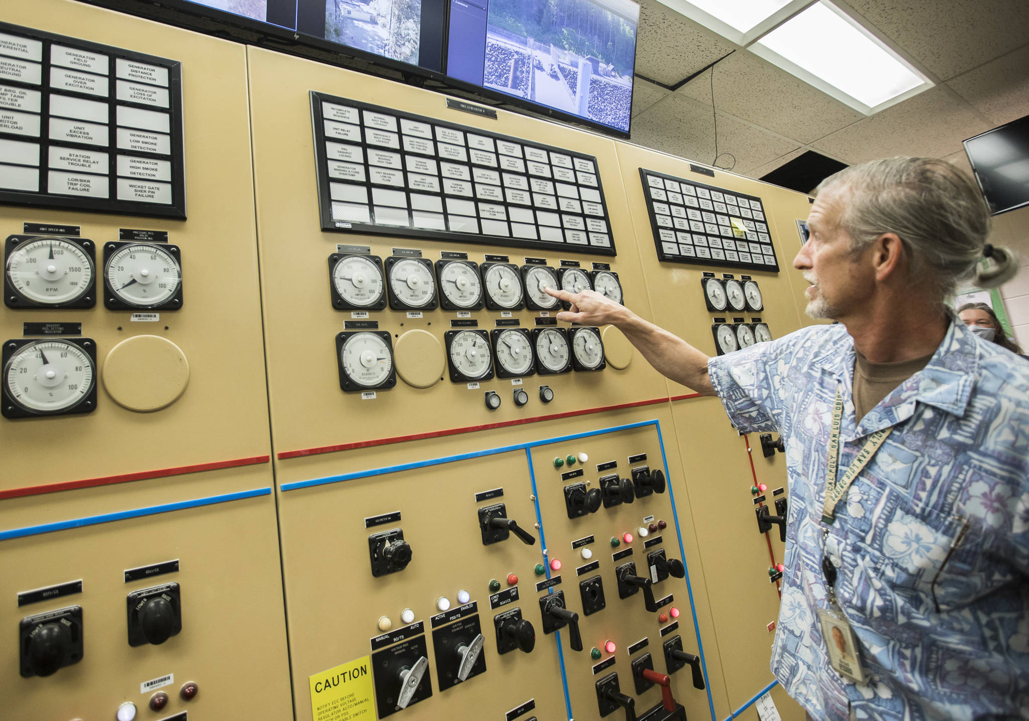 PUD generation senior manager Brad Spangler points out a megawatt meter for one of two generators that provide power to the City of Everett at the Henry M. Jackson Hydroelectric Project on Friday in Sultan. (Olivia Vanni / The Herald)