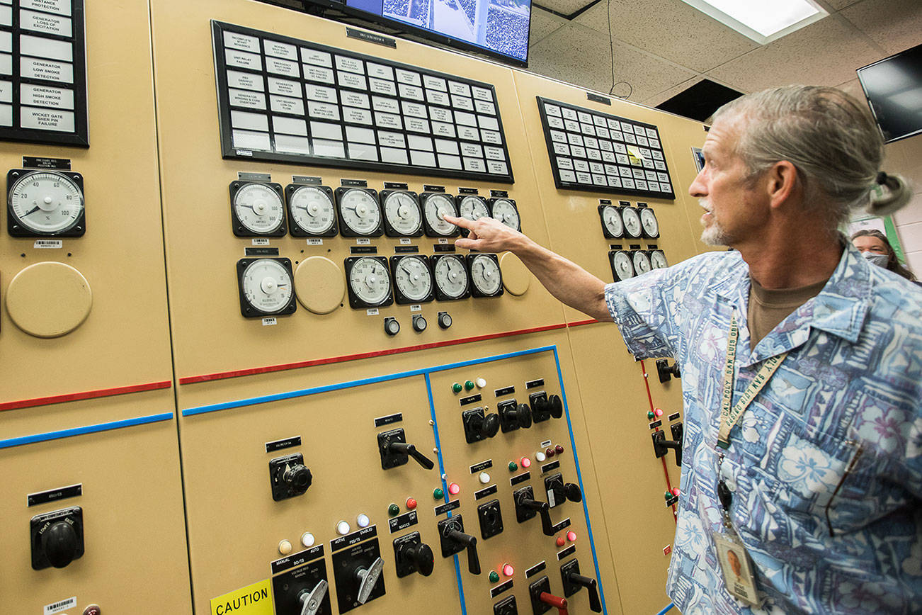 PUD Generation Senior Manager Brad Spangler points out a megawatt meter for one of two generators that provide power to the City of Everett at the Henry M. Jackson Hydroelectric Project on Friday, July 23, 2021 in Sultan, Wash. (Olivia Vanni / The Herald)