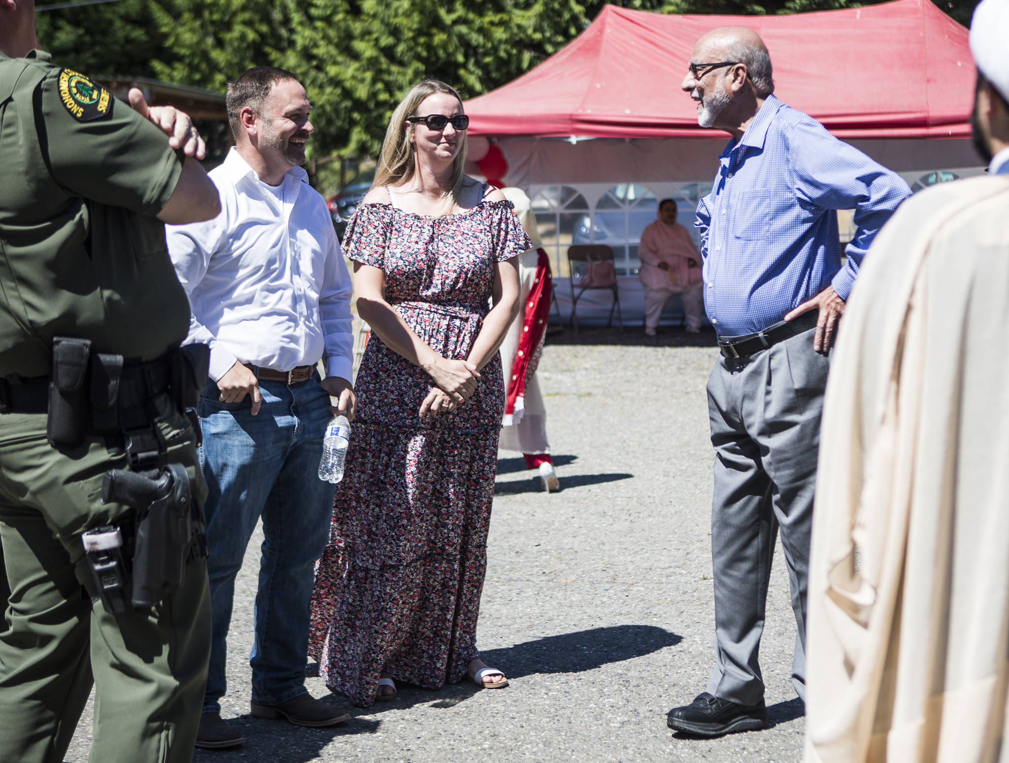 Snohomish County Sheriff Adam Fortney (left) and Husaynia Islamic Society of Seattle vice president Masood Zaidi (right) chat at the Eid ul Adha celebration Saturday in Snohomish. (Olivia Vanni / The Herald)