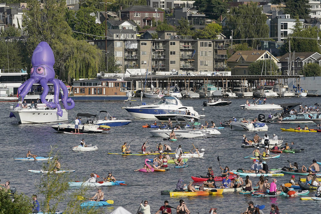 Fans on kayaks and boats, including one sporting a giant inflatable octopus, float on Lake Union on Wednesday during the Seattle Kraken’s NHL hockey expansion draft event in Seattle. (AP Photo/Ted S. Warren)
