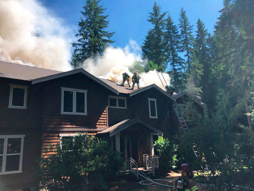 Fire crews fought the flames from the home’s roof before evacuating due to increased danger. (Snohomish Regional Fire and Resuce)
