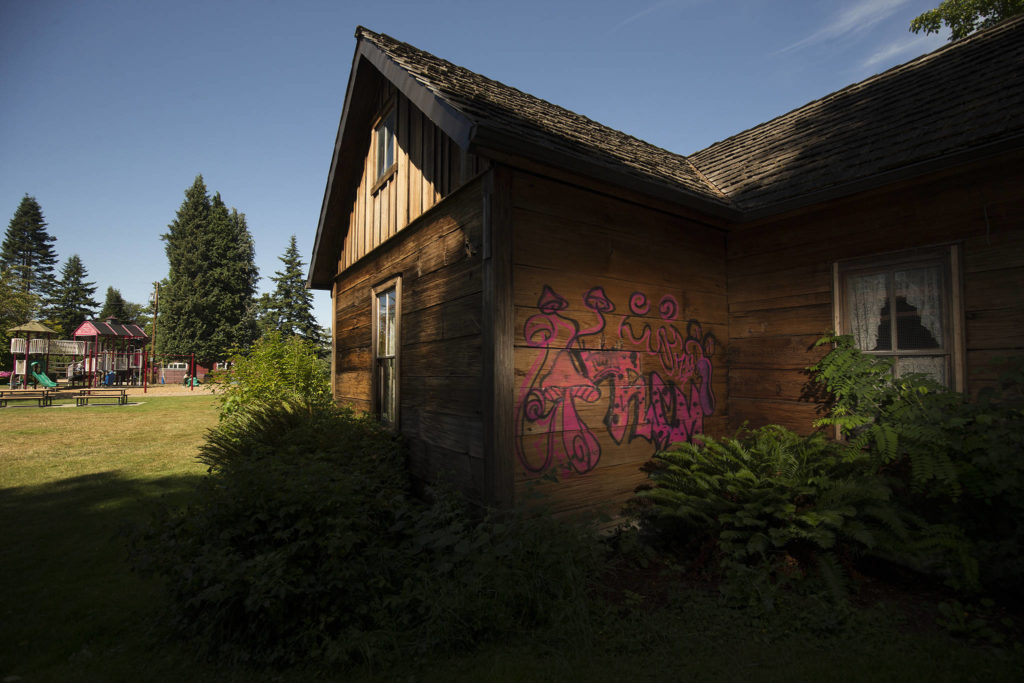Graffiti can be seen on the back walls of the Pioneer Gehl House in Jennings Memorial Park in Marysville. (Andy Bronson / The Herald)
