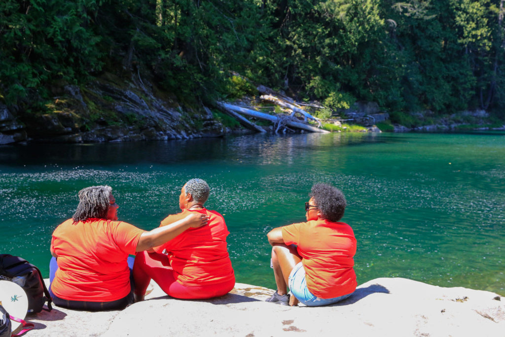 Family and friends gather by the Skykomish River at Eagle Falls in memory of Devin Shelby. (Kevin Clark / The Herald) 
